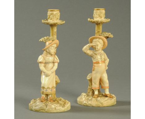 A pair of Royal Worcester figural candlesticks, signed "Hadley" and each with puce printed mark, Registration No. 43551, also