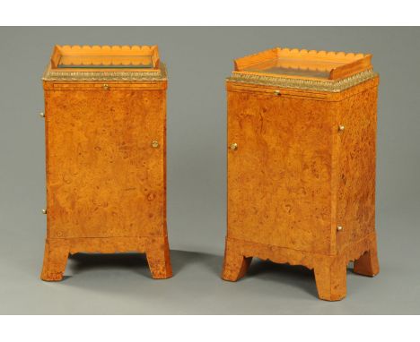 A pair of burr walnut and gilt painted bedside cabinets, in the Biedermeier style, with glass tops, slide and door enclosing 