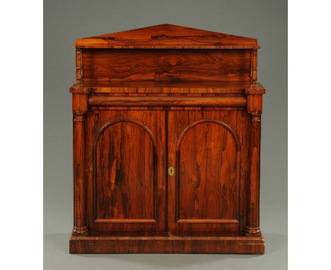 An early Victorian rosewood chiffonier, with triangular pediment and shelf supported by turned columns, the base fitted with 