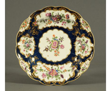 A Worcester Scale Blue porcelain lobed dish, decorated with flowers.  Diameter 25 cm.    CONDITION REPORT:  This bowl has sev