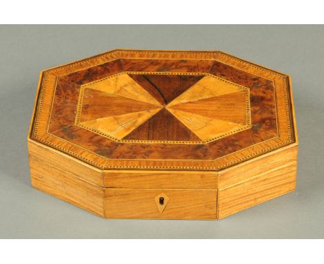 A George III inlaid satinwood octagonal games box, containing playing cards and counters.  Length 26 cm, depth 21 cm, height 