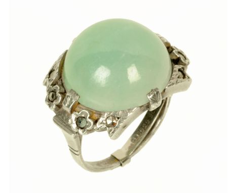 A jade ring in white coloured metal mount and shank, size P.