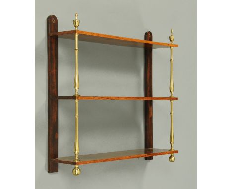 A 19th century rosewood three tier hanging shelf unit, with brass supports and finials.  Width 74 cm, height 71 cm (see illus