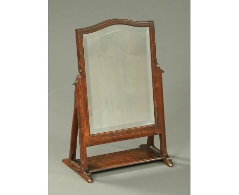 An Arts & Crafts oak framed toilet mirror, with bevelled glass and angled supports.  Width 41 cm.    CONDITION REPORT:  Both 
