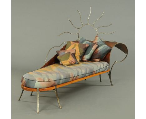 A contemporary chaise longue, wood and metal, with squab cushion and five further cushions.