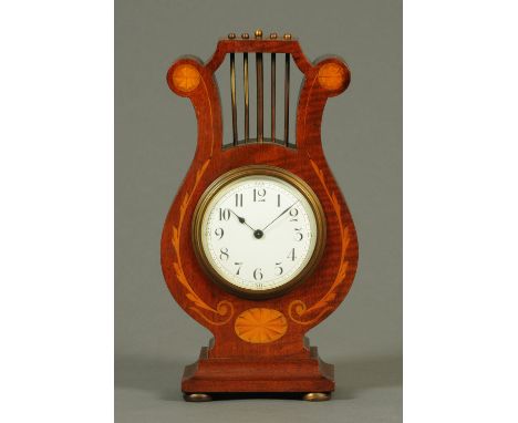 An Edwardian inlaid mahogany lyre shaped clock, with single-train movement.  Height 26.5 cm, width 15 cm.    CONDITION REPORT