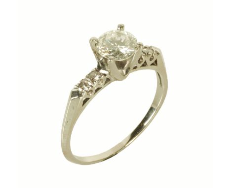 A solitaire diamond ring, with two diamonds to each shoulder, white coloured metal shank, size R/S (see illustration).