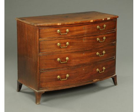 An early 19th century mahogany bowfronted chest of drawers, four long graduated drawers with geometric brass drop handles and