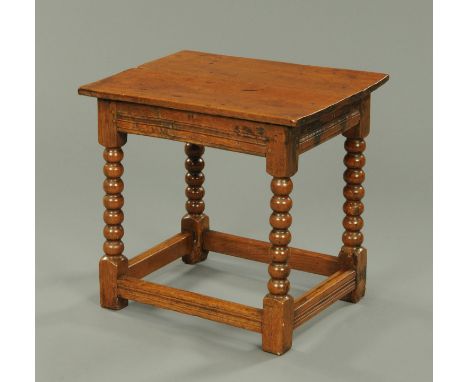An antique oak table, rectangular, with bobbin turned supports and low stretchers.  Length 60 cm.   CONDITION REPORT:  This i
