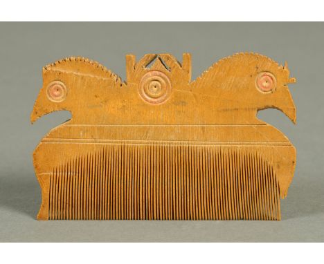 A 17th century carved boxwood comb, with hen motif, with copy invoice for £500.  Length 10 cm (see illustration).   CONDITION
