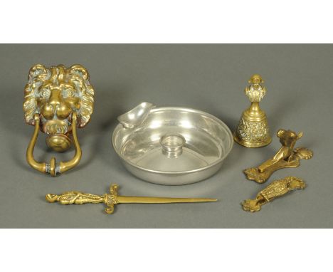 A brass lions head door knocker, brass letter knife, bell, two smaller door knockers and a pewter pipe ashtray, diameter 20 c