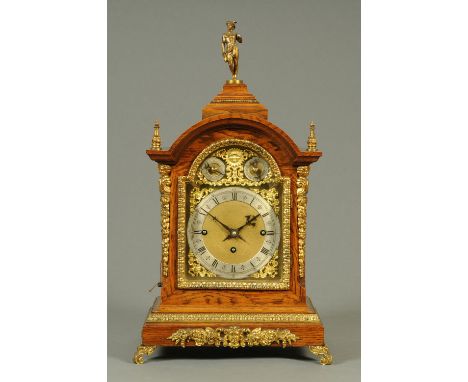 A late 19th/early 20th century oak bracket clock, with three-train chain driven fusee movement striking on five gongs.  Heigh