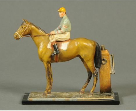 A painted metal race horse and jockey table lighter.  Height 18 cm. 