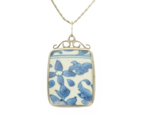 A piece of shipwrecked Ming china, rubover set in silver and on a silver 20 inch chain.