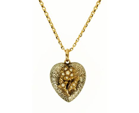 A gold and silver coloured heart shaped locket, with glass back, set with seed pearls and with 9 ct gold chain. 