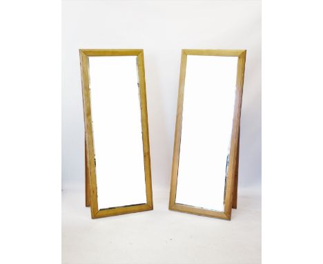 Two contemporary light oak cheval mirrors,the bevelled mirrored plate within a moulded frame with rear easel support,166cm H 