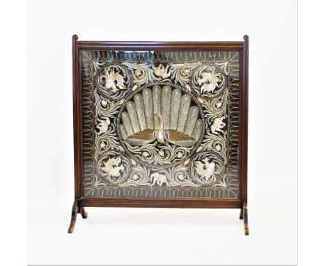 A 20th century walnut framed needlework firescreen, the Indian style panel embroidered using silver, gilt threads and sequins