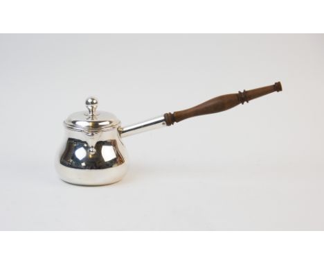 An early 20th century silver plated brandy pan, of typical plain polished form, with sparrow beak spout, the hinged cover wit