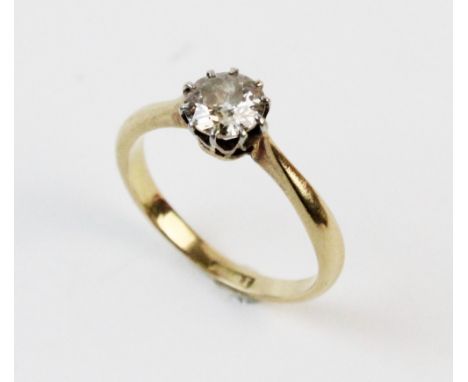 A diamond solitaire ring, the central round brilliant cut diamond measuring approx. 0.75 carats, claw set in white metal, con