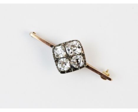 A diamond set bar brooch, comprising four old cut cushion diamonds set to a white metal rhombus shaped mount, 1.5cm x 1.5cm, 