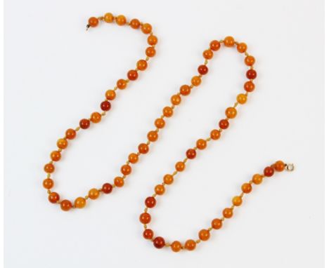 A 'butterscotch' amber bead necklace, comprising 65 off-round beads, each measuring approx. 10mm x 11mm, spring ring fastener