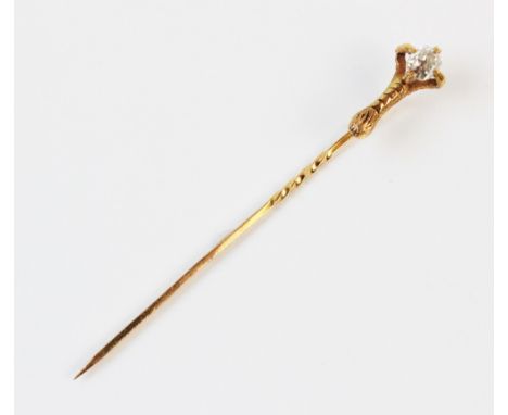 A French 18ct gold diamond set stick pin, the old cushion cut diamond measuring 4mm x 5mm, set to a yellow gold eagle's claw 