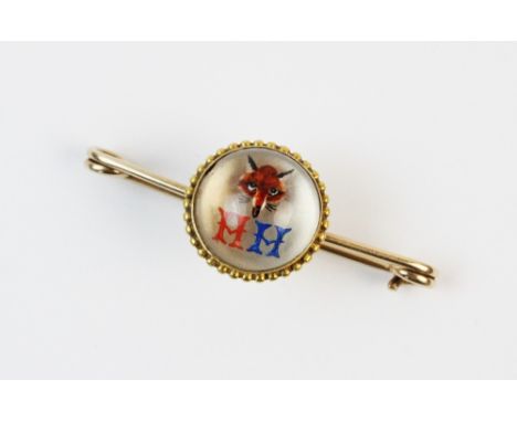 A painted crystal bar brooch, depicting a fox and letters 'HH' in a rock crystal cabochon, set to a yellow metal border surro