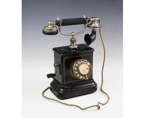 An early 20th century Danish pillar telephone magneto, Jydsk Telefón Aktieselskab, hand-crank mechanism, to a black rounded p