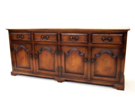 A George III style stained ash dresser base by Sitting Firm, late 20th century, the rectangular moulded top above four frieze
