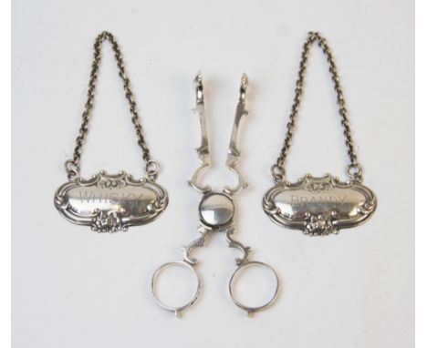 A pair of Victorian sugar nips, George Unite, Birmingham 1876, with scrolling form body and shell shaped bowls, 11.7cm long, 