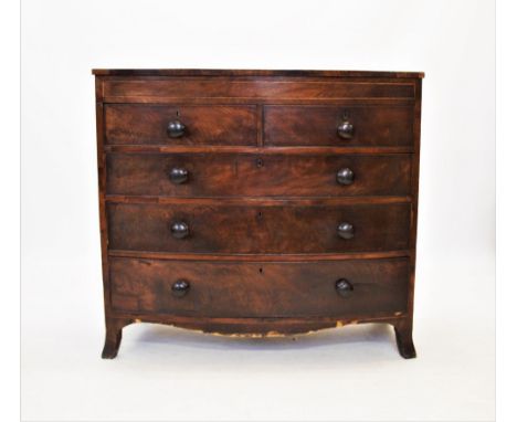 An early 19th century bow front mahogany chest of drawers, with an arrangement of two short and three long drawers, applied w