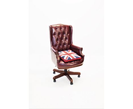 A mauve leather high back office chair, 20th century, the button back with dwarf wing backs above a bow front seat, raised up