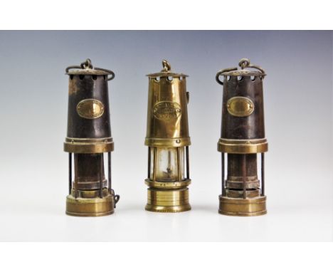 Three vintage brass miners lamps, each of typical tapering form, two applied with makers plaque 'Patterson Lamps Ltd, Gateshe