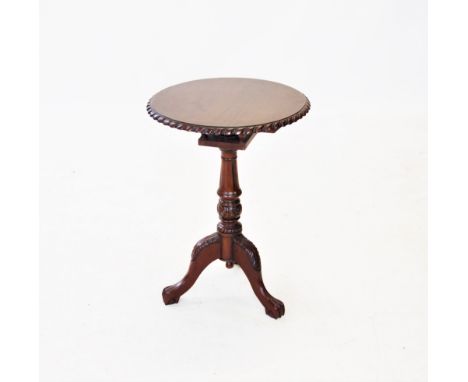 A Chippendale style mahogany tripod table, 20th century, the circular top with a gadrooned border, raised upon a bird cage mo