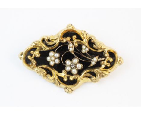 A Victorian mourning brooch, the rhombus shaped brooch with black enamel backing and applied floral decoration set with seed 