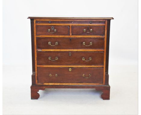 A George III mahogany chest of drawers, the rectangular moulded top with rounded front corners above a brush slide, two short