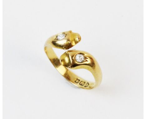An early 20th century 18ct diamond set snake ring, the twist design stylized snake heads each set with an old cut diamond, co
