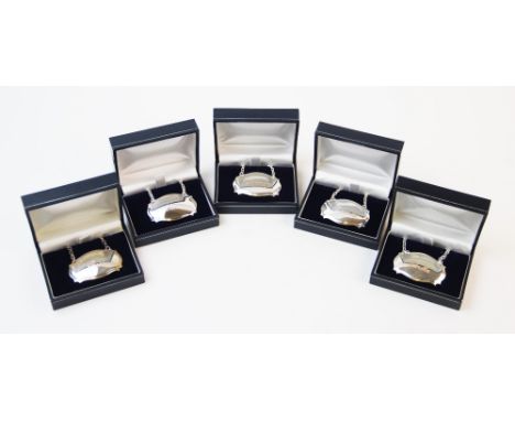 A collection of five white metal decanter labels, each of lozenge type form, engraved for 'Gin', 'Whisky', 'Brandy', 'Vodka' 
