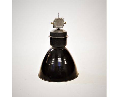An industrial metal lamp, mid 20th century, of typical domed form with a white enamelled interior, below the cylindrical elec