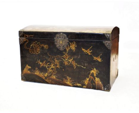 A 19th century Japanese black lacquered domed trunk, adorned in gilt with birds in a tree lined landscape and applied with br