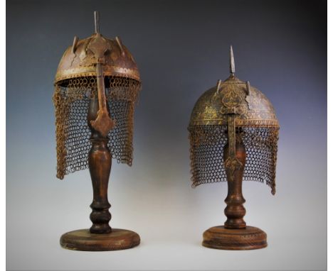Two Kulah Khud type helmets, the first with a sliding nose bar, spike finial and chain link neck guard, cast in relief with f