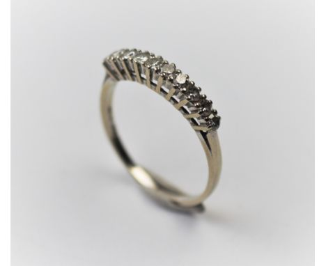 A diamond set half-eternity ring, comprising ten eight-cut diamonds claw set to a plain polished white gold shank, stamped ?7