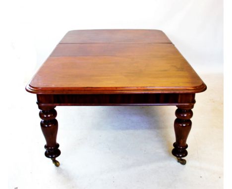A Victorian mahogany extending dining table, with one extra leaf, the rectangular thumb moulded top with rounded corners, rai