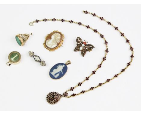 A selection of antique and vintage jewellery, to include a carved shell cameo brooch set to a yellow metal scroll design bord