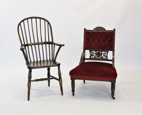 A Victorian walnut and upholstered low seat chair, with a button padded back above a carved open work splat and sprung seat, 