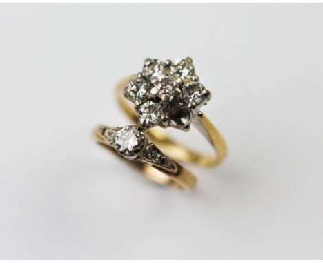 A diamond floral cluster 18ct yellow gold ring, comprising six brilliant cut diamonds claw set in white metal, set to a plain