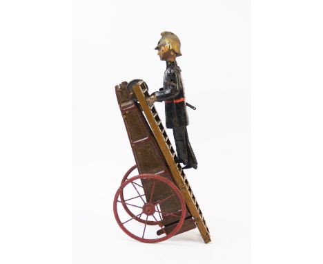 An early 20th century tin plate clockwork fireman with extending ladder, figure painted with black uniform and gilt helmet, t