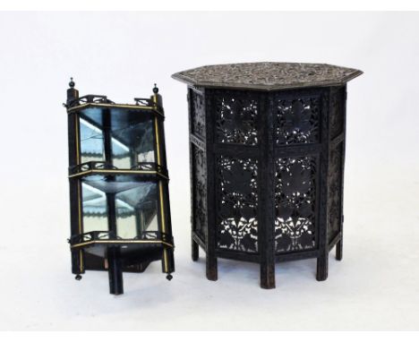 An early 20th century Anglo Indian carved hardwood  table, the ebonised octagonal top carved in relief with trailing vinery a