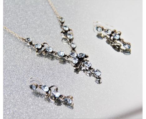 A topaz set necklace, designed with thirteen claw set topaz, with milgrain foliate curl detail, to a belcher link chain and s