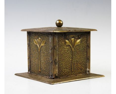 An early 20th century brass Art Nouveau tea caddy, of square planished form with stylized sprig motif, hinged cover with ball
